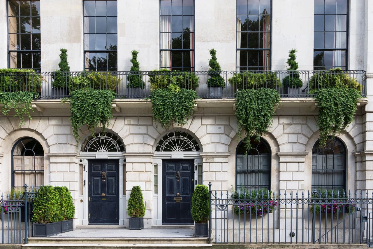 A stucco-fronted Georgian terrace with iron railings, the kind of older, larger home a Level 3 survey suits
