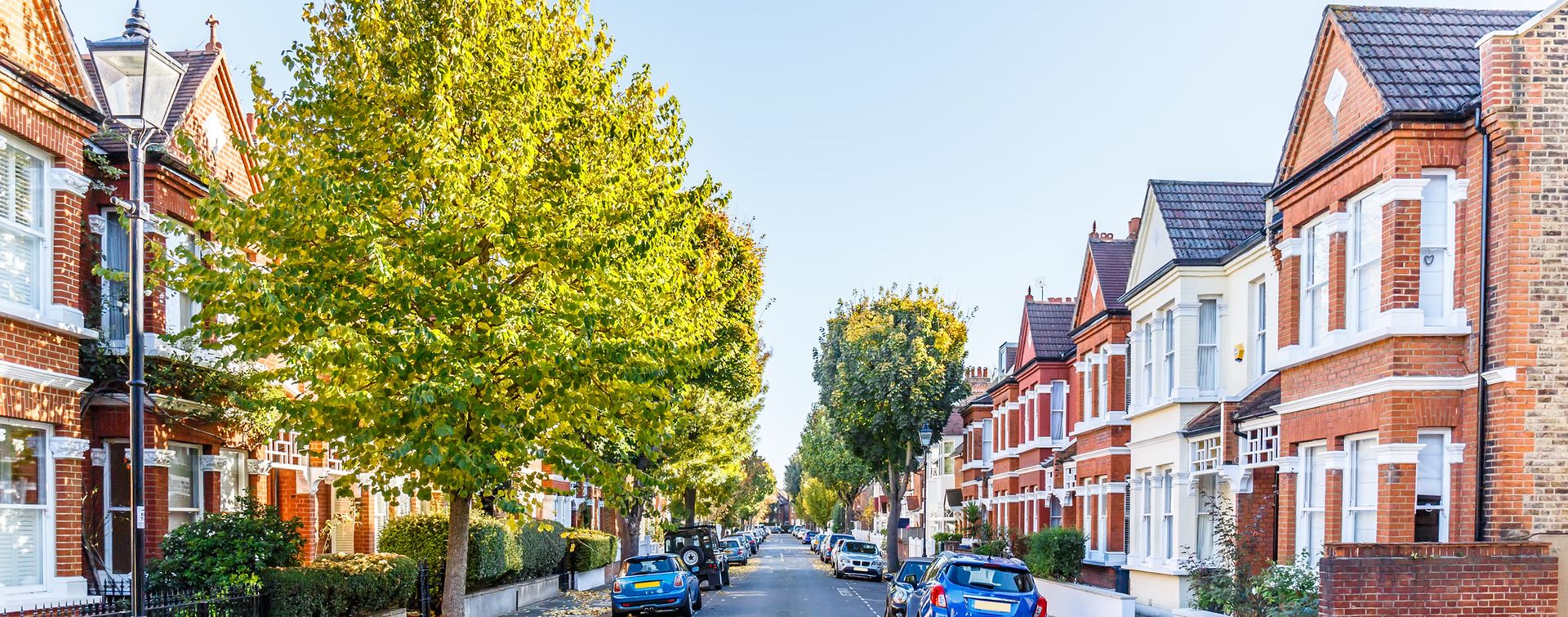 Tree-lined street of Victorian terraced houses in autumn